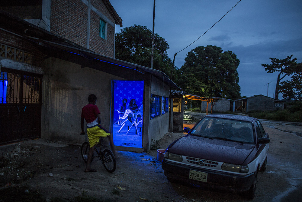 Jose Maria Morelos, Oaxaca, August 22nd, 2014. A bar in a late afternoon with rain in Santa Maria Xicometepec, also known as La Boquilla, where the great majority of residents are Afromexicans. For years Mexico's black communities have lived isolated and often forgotten, but still practicing some of the traditions of their African descendants, largely slaves and escaped slaves who fled into remote hills in southern Mexico. But a new effort is underway to officially count the population in the next national census in February, what advocates call a key step in bringing recognition to the communities and making the country more aware of people from what is commonly called "the third root." (after European and indigenous roots). Photograph by © Adriana Zehbrauskas